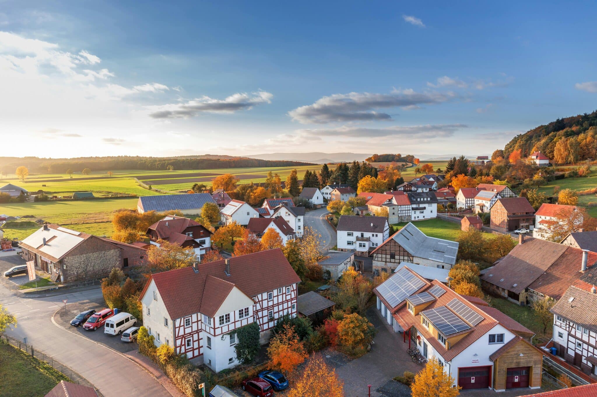 Autumn aerial view of a quaint village, highlighting colorful trees, perfect for Billings Realtor promotional content.
